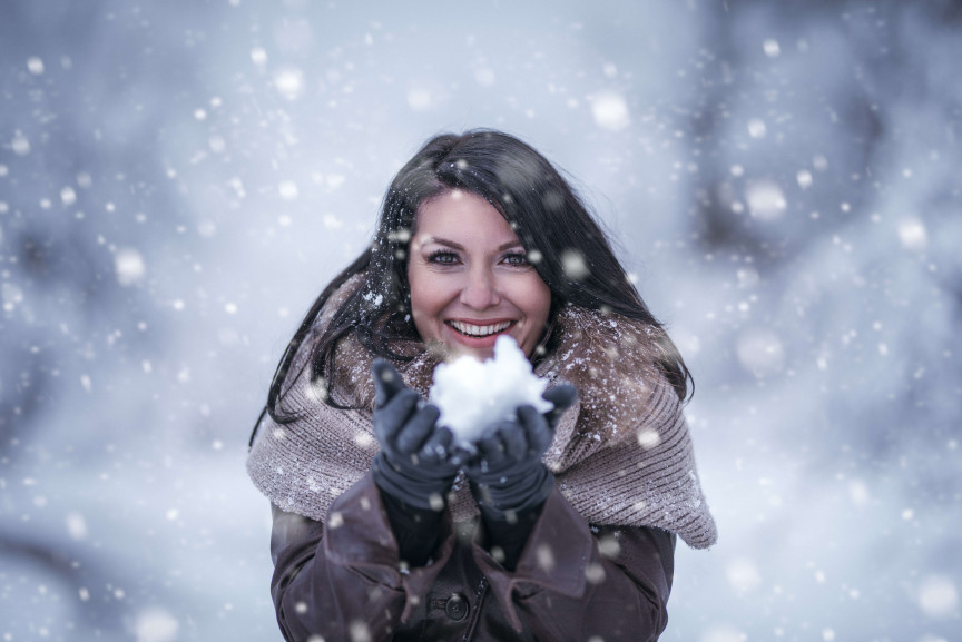 Woman in winter with a snowball