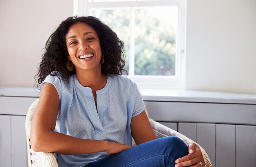 Tummy Tuck - Woman smiling in chair