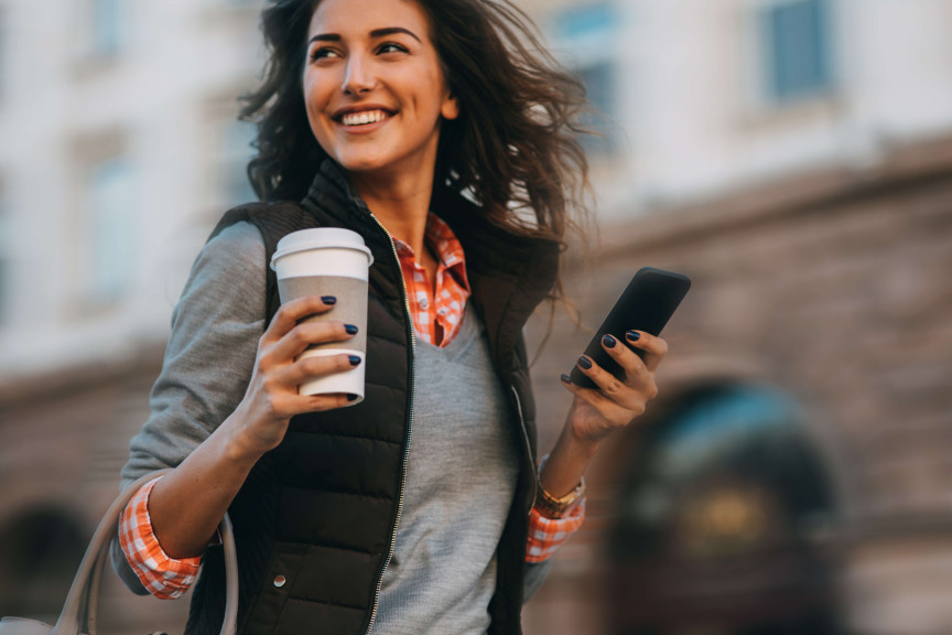 Woman with coffee and phone