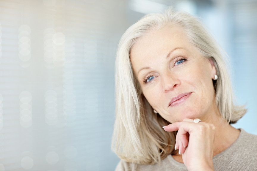 smiling older woman with blue eyes and shoulder length hair