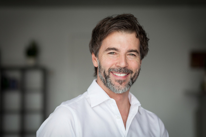 smiling man with greying beard